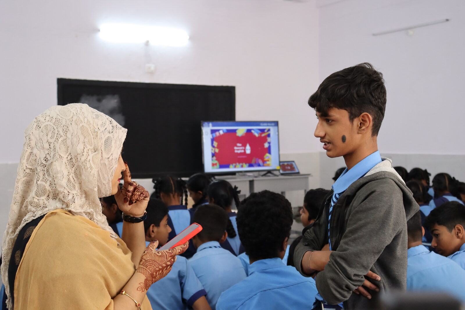English Quest teacher engaging with a student